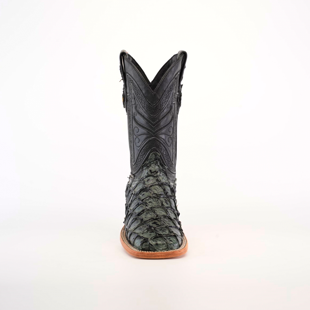 The Exotic Piraruco Fish - Charcoal- Square Toe is a stylish cowboy boot for fashion lovers, featuring a dark, intricately designed leather upper made from Piraruco fish leather. It has textured patterns on the lower part with a pointed toe and light brown sole, all on a plain white background.