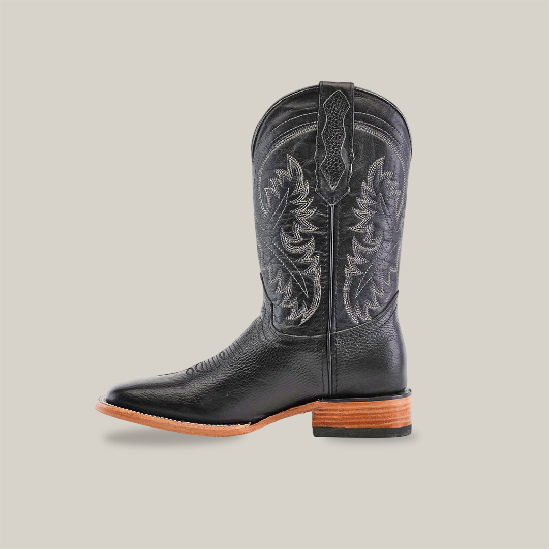 The Barcelona Black - Square Toe boots are premium cowhide leather Western-style cowboy boots with intricate shaft stitching, a pointed toe, side pull tab, and wooden heel. These handcrafted pieces beautifully contrast against a plain white backdrop.