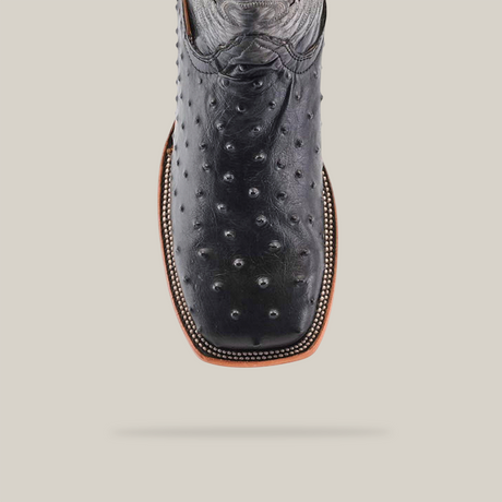 Top view of the Karoo Ostrich Print Black boot, a premium cowhide creation with a square toe. Masterfully handcrafted, it features a textured ostrich print with distinctive bumps and detailed sole stitching.