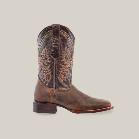 The Azkar Tan - Square Toe boot is a single rustic brown cowboy boot with detailed embroidery and a slightly worn finish on a white background. Made from premium cowhide leather, it features traditional Western design, artisanal excellence, a thick heel, and pointed toe.