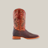 The Azkar Moka - Square Toe is a cowboy boot crafted from cowhide leather with a brown lower section and a reddish-brown patterned upper featuring decorative stitching. It includes a wooden heel and square toe, displayed against a plain white background.