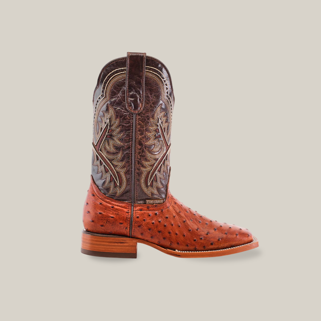 The Karoo Ostrich Print Cognac - Square Toe boot highlights a brown leather upper with intricate stitching and textured Karoo Ostrich Print on the foot. It features a smooth wooden heel, set against a plain white background, epitomizing the charm of Square Toe boots.