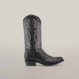 The Karoo Ostrich Print Black boot features intricate white stitching and decorative patterns on ostrich print leather. It elegantly stands out against a plain white background with its classic round toe and stacked heel.