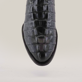 A close-up of the Crocodile Tail Print Black boot showcases its unique texture and round toe design against a plain white background.