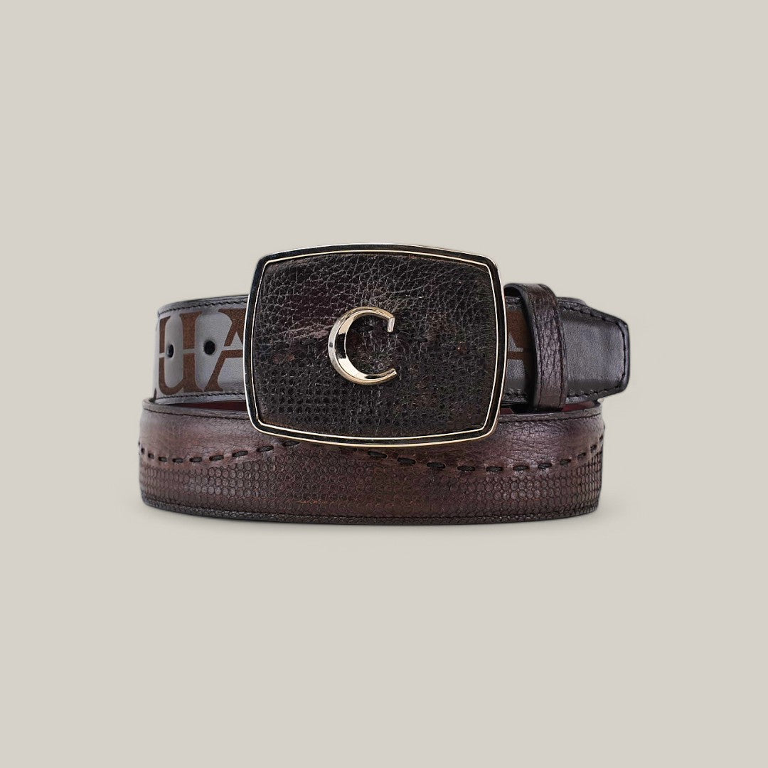 The Firenze Grey Shadow Deer Laser & Woven Belt - BC237, with its rolled brown leather and a textured rectangular buckle featuring a gold C, elegantly displays against a light gray background, epitomizing luxury for those who value timeless style.