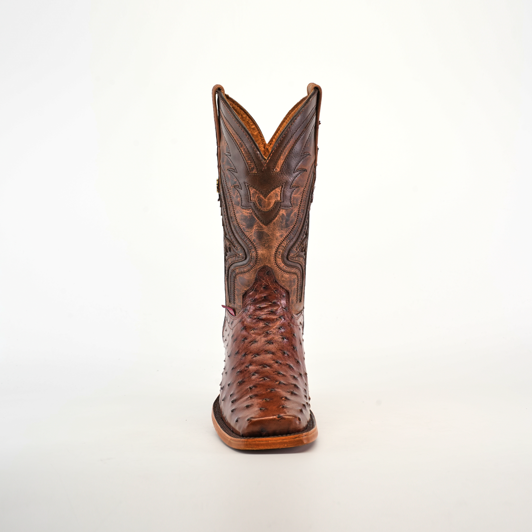 The Exotic Ostrich - Brown - Rodeo Toe boot showcases superior craftsmanship with intricate stitching and patterns on the shaft. The textured design on the toe enhances its artisanal beauty, standing centered on a plain white background.