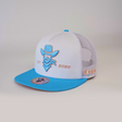 The De Rancho Cap Baby Blue is a white and light blue trucker cap featuring an embroidered cowboy design, EST. 2020, and BE LEGENDARY text, celebrating Western heritage. It includes a flat brim and mesh back.