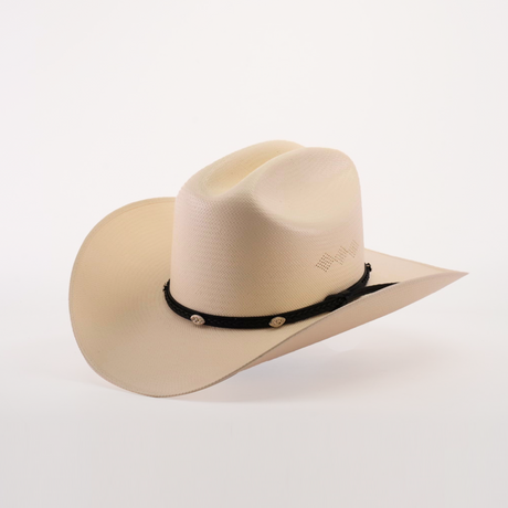 The 500X Sinaloa Straw Hat is a cream-hued cowboy hat with a slightly curved brim and indented crown, set against a plain white backdrop. It boasts timeless style and top-notch quality, featuring a black band with decorative emblems around the crowns base.