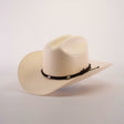 The 1000X Sinaloa Straw Hat is a cream-colored cowboy hat with a wide brim, featuring exceptional quality and a black braided band adorned with small silver embellishments, set against a plain white background to highlight its elegant design.