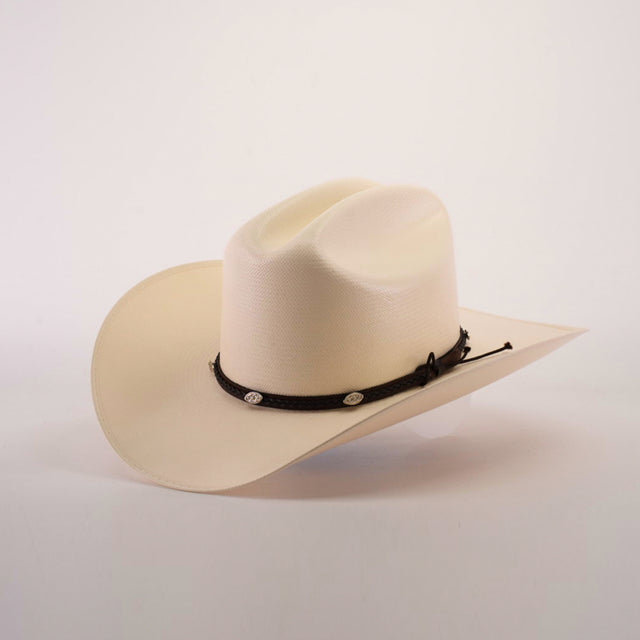 The 1000X Sinaloa Straw Hat is a cream-colored cowboy hat with a wide brim, featuring exceptional quality and a black braided band adorned with small silver embellishments, set against a plain white background to highlight its elegant design.