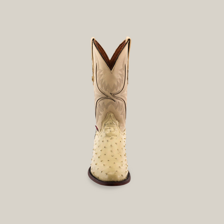 A front view of the Exotic Full Quilt Ostrich - Bone - Round Toe boot highlights its genuine cream ostrich leather, brown sole, and detailed upper shaft stitching against a plain light background.