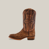 The Exotic Python - Tamarindo boot showcases a single textured leather design with stitched decorations on the shaft, celebrating Western heritage. It features a round toe and low heel set against a simple light beige background.