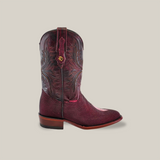 The Exotic Stingray - Wine - Square Toe boot is displayed against a neutral background, showcasing intricate stitching on the shaft and a wooden heel. This expertly crafted boot blends elegance with rugged style.