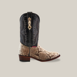 The Exotic Python - Natural - Round Toe is a cowboy boot made with genuine python skin on the lower part and black leather on the upper, featuring ornate stitching. It includes a wooden heel and a small red label near the ankle, exuding exotic allure against a plain background.