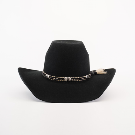 The 6X Brazil Black cowboy hat features a wide brim, crafted from Brazil felt. Its adorned with a braided band accented with silver and a small tuft of sheep wool on the side, and is set against a plain white background.