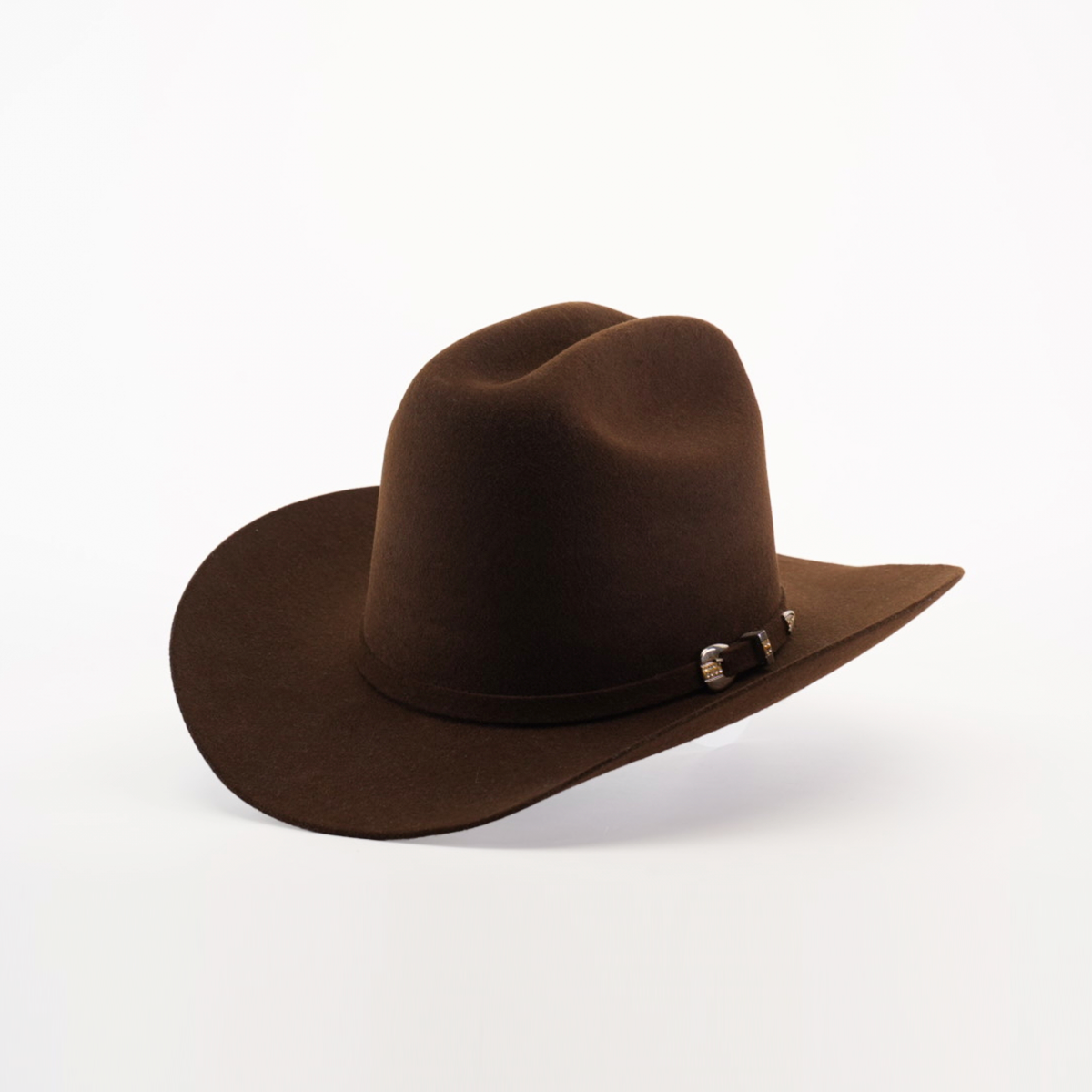 The 6X 2 Carnales Brown cowboy hat features a wide brim and decorative band, crafted from felt, set against a white background.