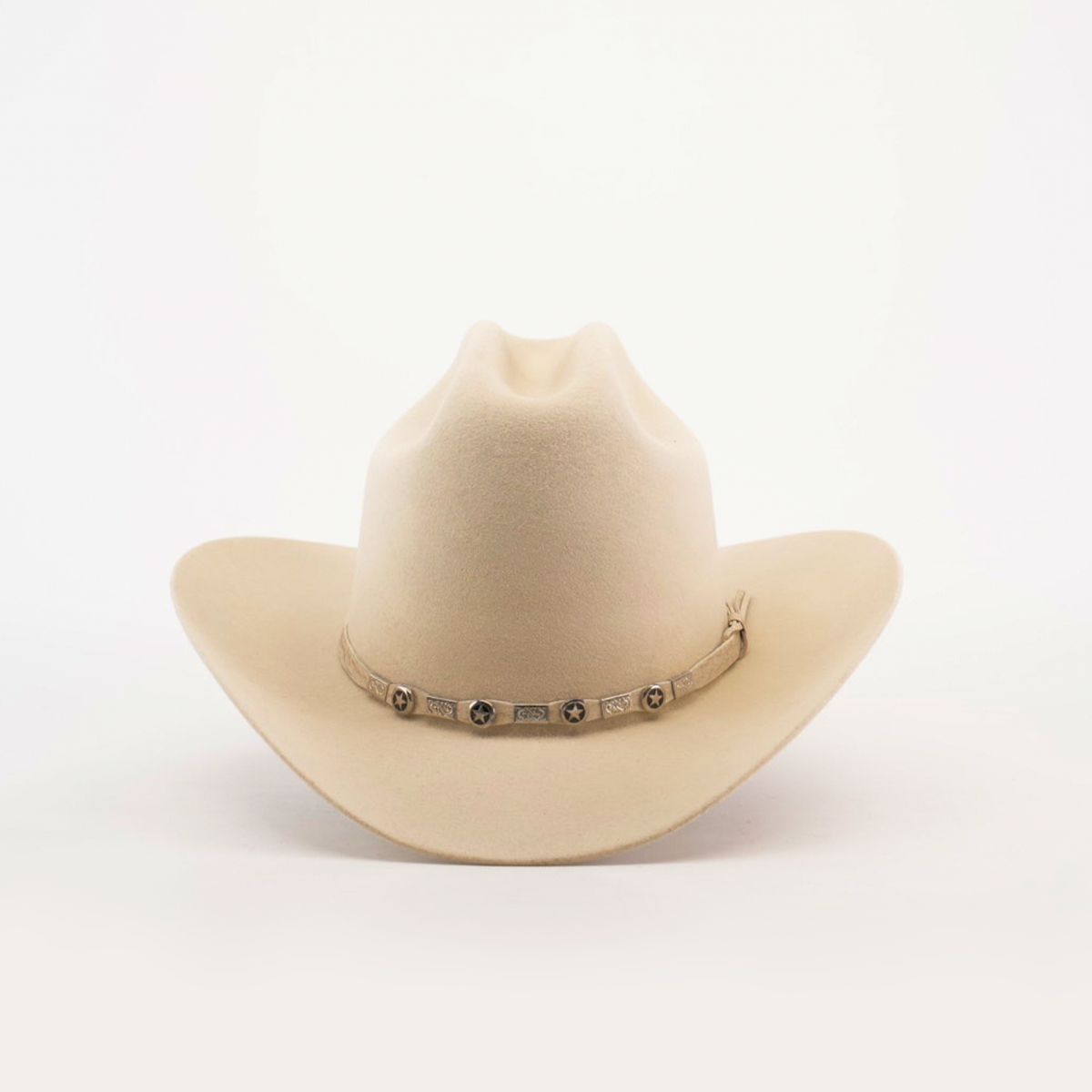 The 6X 2 Carnales Bone is a cream-colored felt hat with a wide brim and a decorative band featuring small conchos encircling the crown, set against a plain white background.