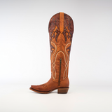 The Miriam Brick - Tall Shaft - Snip Toe is a tall brown leather cowboy boot featuring intricate embroidery and decorative patterns on the upper shaft. Crafted from premium materials, it includes a side zipper and low heel, set against a plain white background.