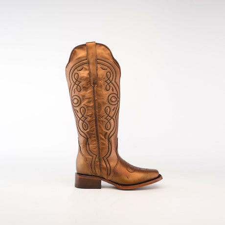 Set against a plain white background, this Eden Copper Tall Shaft boot highlights luxury craftsmanship with intricate side stitching. It pairs a low heel with a narrow aquare toe, blending style and sophistication.