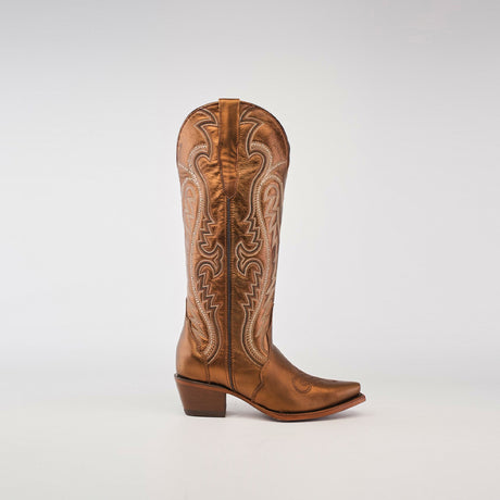 The Nihan Copper - Tall Shaft - Snip Toe, a single tan leather cowboy boot, represents traditional craftsmanship. Its intricate embroidery enhances the snip toe and tall shaft, set against a plain white background, exemplifying handcrafted excellence.