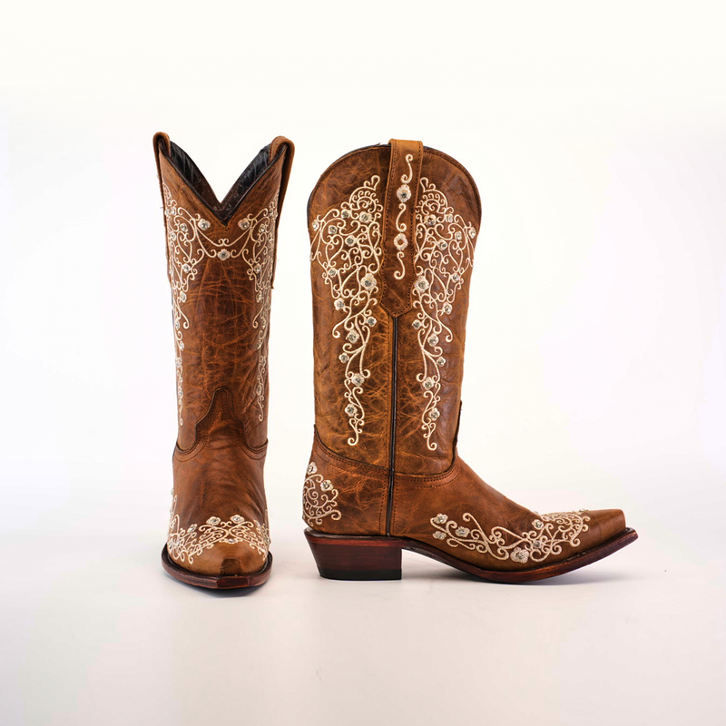 Pair of elegant brown leather cowboy boots with intricate white embroidery featuring swirling floral patterns, displayed against a white background