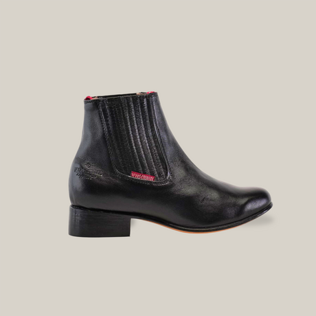 The Napa Black - Round Toe boot, featuring a low heel, elastic side panels, and a handcrafted design, is displayed against a plain white background.