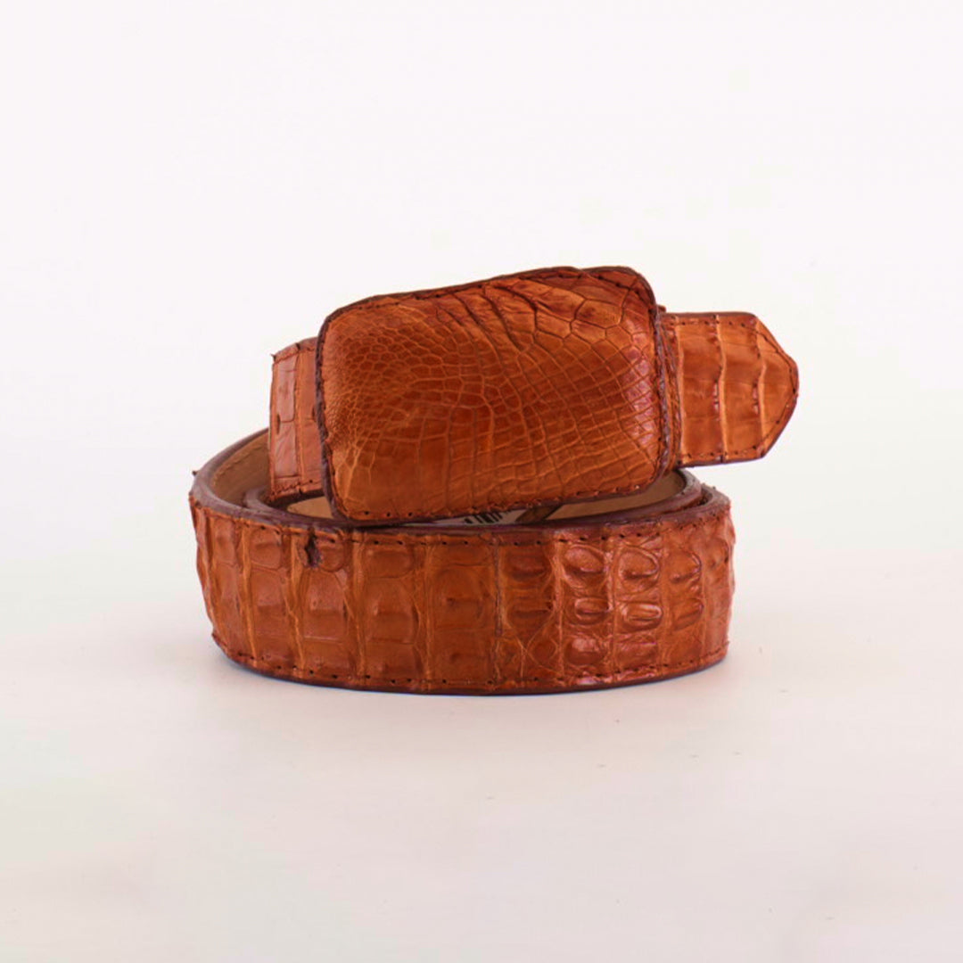 The Exotic Full Quilt Caiman - Brandy Belt features a large, textured buckle with a distinct crocodile skin pattern, coiled elegantly on a plain white background, exemplifying exquisite exotic leather craftsmanship.