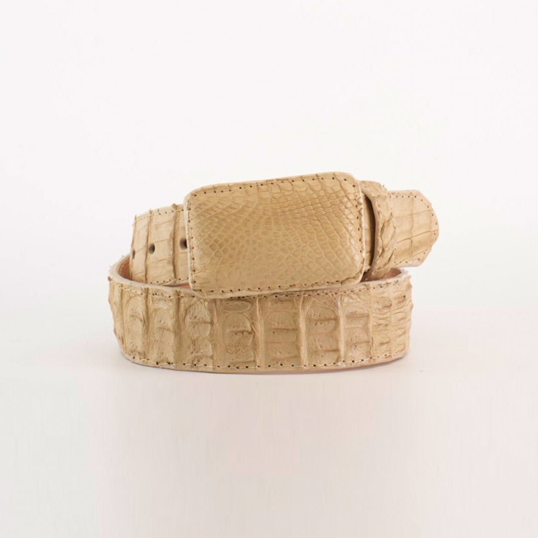 The Exotic Full Quilt Caiman - Bone Belt is an eye-catching light beige accessory with a textured crocodile leather surface and unique pattern. Coiled circularly, it features a rectangular buckle and rests against a plain white background.