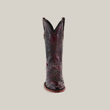 An ornate, handcrafted cowboy boot in Exotic Full Quilt Ostrich leather is shown from the front, featuring a glossy Black Cherry finish with intricate patterns and decorative stitching on a plain background.