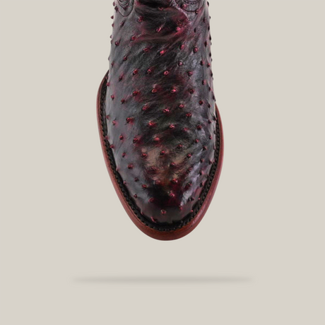 Top view of the Exotic Full Quilt Ostrich - Black Cherry - Round Toe boot, highlighting its handcrafted ostrich leather texture with raised bumps, set against a plain gray background.