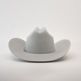 The 10X Jerarca Platinum, a light gray fur felt cowboy hat from the Larry Mahan collection, features a wide brim and a pin on the band, photographed against a plain white background.