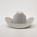 The 500X Superior Platinum is a luxurious light gray cowboy hat made from premium belly beaver fur, with a wide brim, top crease, and decorated band, set on a plain white background.