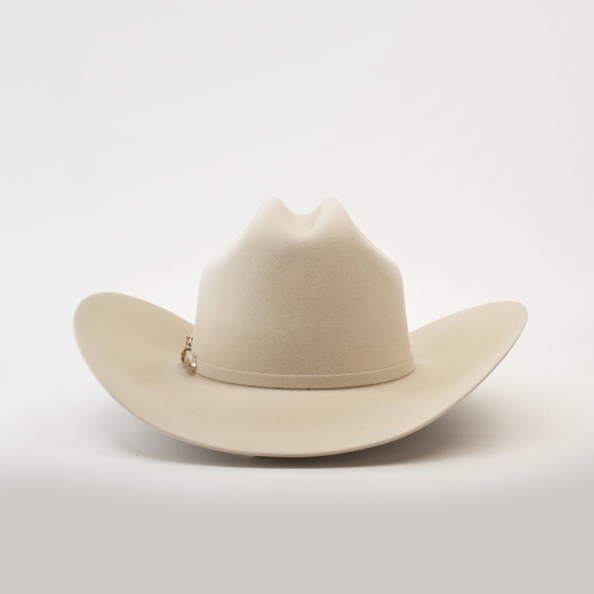 A beige western hat featuring a wide brim and slight crease at the crown, set on a plain white background. A small decorative band encircles the base, highlighting its genuine Larry Mahan 1000X Imperial Belly craftsmanship.