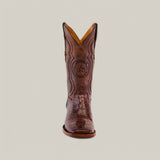 A single brown cowboy boot, crafted from Exotic American Alligator Belly, features intricate stitching and a central star emblem, displayed against a plain backdrop.