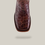 Exquisitely crafted luxury Exotic American Alligator Belly boots in brown, featuring a square toe design. Made from genuine alligator leather, these boots exude sophistication against a neutral background and are elegantly displayed from the top view.