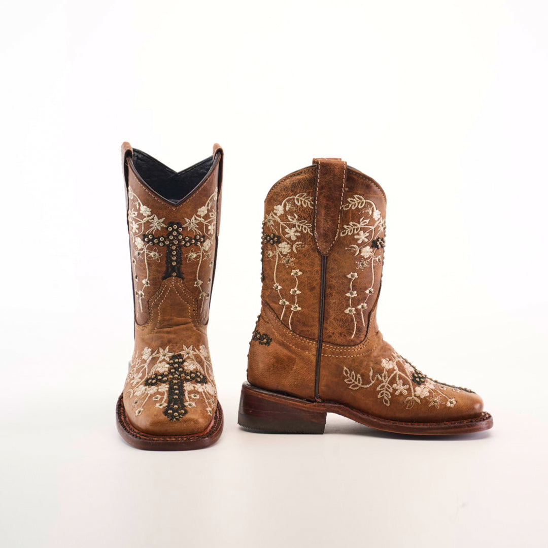 The Margacruz Studs Orix - Square Toe girls cowboy boots are made from premium leather, adorned with intricate white floral embroidery and decorative designs, shown against a white background.