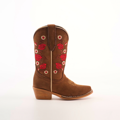 The Mia Copper Suede - Snip Toe cowboy boot features red and white floral embroidery on its brown shaft, complemented by a wooden heel and pull strap. This handcrafted leather piece highlights premium craftsmanship against a plain white background.