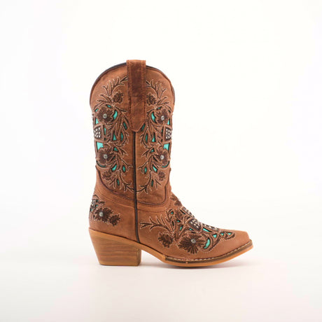 The Alamo Studs Honey -+ Snip Toe is a brown cowboy boot made from cowhide leather, featuring detailed turquoise and black floral and geometric embroidery. It has a short heel and is presented on a plain white background.