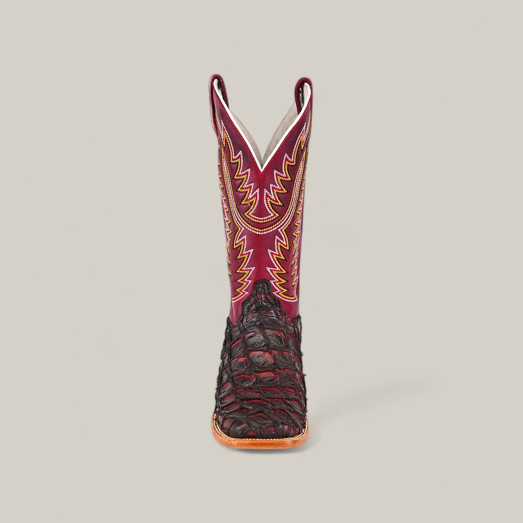 The Maverick - Wild Cherry - Square Toe boot features a dark brown textured lower, a red upper shaft with yellow and orange stitching, and a square toe, displayed facing forward against a plain light background.