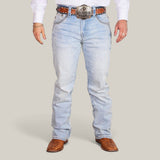 Someone dressed in Western Blue Straight Fit Embroidered Jeans (WJ2343), a white shirt, brown crocodile-patterned cowboy boots, and a large decorative belt buckle paired with a brown belt against a plain grey backdrop.