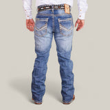 A person dressed in a white shirt, patterned belt, and Western Blue Straight Fit Embroidered Jeans - W435 with detailed stitching on the back pockets. Brown shoes complete the ensemble against a plain light gray background.