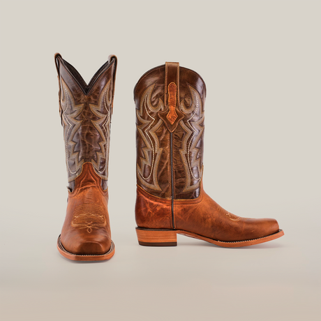 Experience cowboy life with Fresno Tan boots in Wide Cutter Toe. Made from premium cowhide leather, they feature intricate shaft stitching and stacked heels, showcasing their classic design against a plain white background.