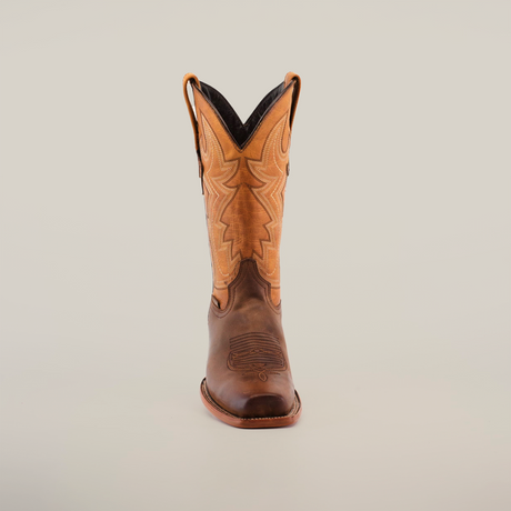 An Azkar Tan - Wide Cutter Toe cowboy boot, featuring a cowhide leather lower and a tan intricately stitched upper, stands upright against a white background.