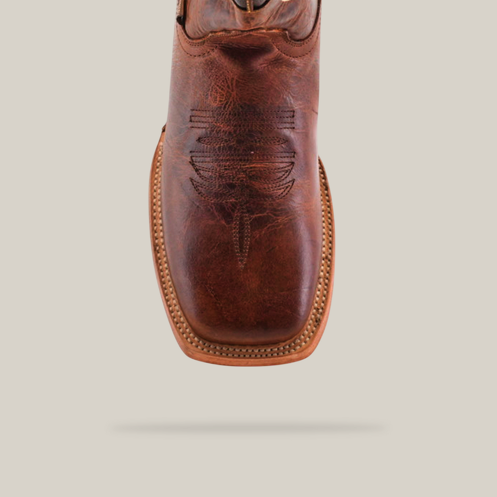 The Fresno Shedron Star - Square Toe boot features a close-up of its brown leather crafted with premium cowhide, intricate upper stitching centered for emphasis, and a lighter tan sole with a stitched border. The backdrop is white for better contrast.