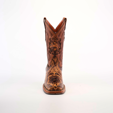 The Handtooled Leave Orix cowboy boot exhibits a front view of premium brown cowhide leather, adorned with floral and geometric embroidery on white. Its elegant design is complemented by handtooled details and a slip-resistant sole for enhanced stability.