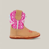 The Holly boot features a brown base with a natural pink Aztec zigzag pattern on the shaft, hola stitched in red on the side, a square toe, and a tan leather sole. Its perfect for completing any outfit against a light gray background.