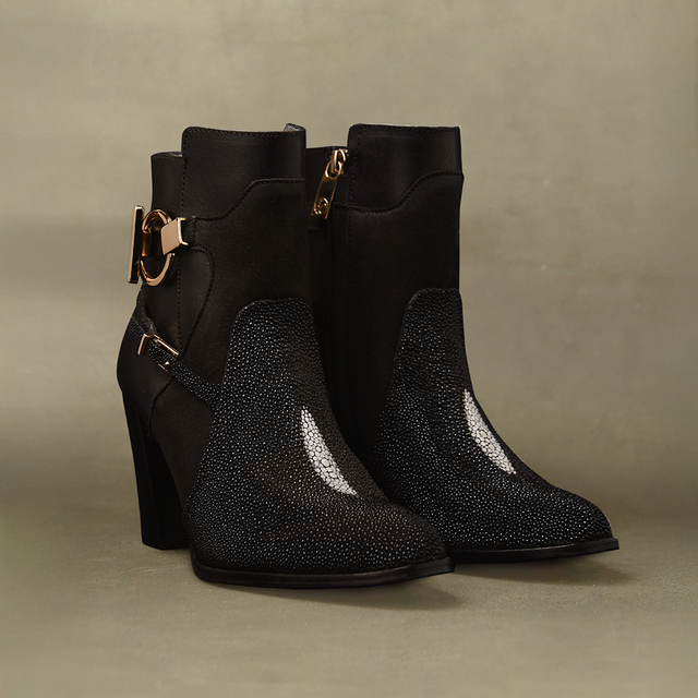 A pair of Black Stingray Zipper - Round Toe ankle boots, featuring high heels, metallic embellishments, textured stingray leather, and side zippers, styled against a neutral background.