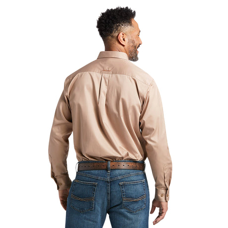 A man with short curly hair stands back to the camera in a Solid Twill Classic Fit Shirt Kaki (10000505) and blue jeans, hand on hip highlighting his brown leather belt. The plain white background enhances the premium cotton twill texture.