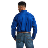 A man with short black hair wears a Solid Twill Classic Fit Shirt Blue (10006660) made of 100% cotton, paired with blue jeans and a brown belt. Facing away, he showcases the back of his classic outfit.