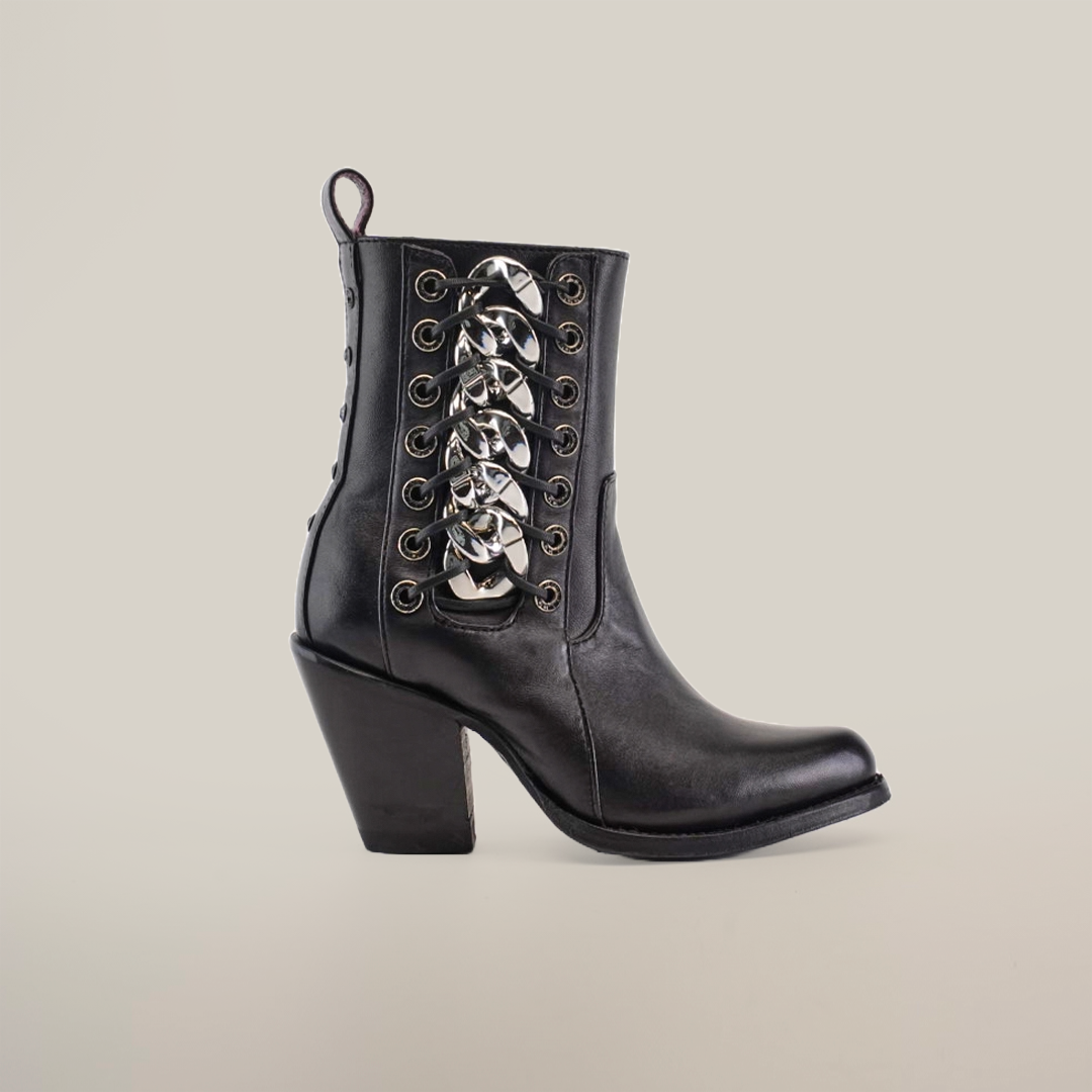 The Francia Rings Bootie Black - J Toe from the Platinum Collection is a handcrafted black leather ankle boot with a chunky heel and metallic buckles along the front laces, featuring sleek eyelets on either side of the lacing for added luxury.